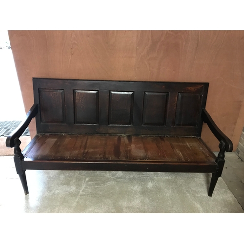 259 - An 18th Century oak hall bench with a panelled back on turned legs - W180cm