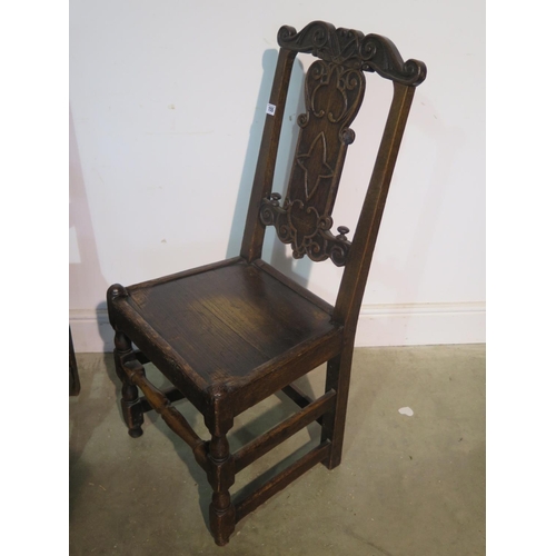 218 - A pair of 18th century carved oak chairs, with solid seats, 100cm tall