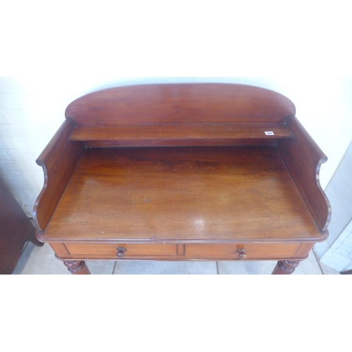 205 - A good quality 19th Century mahogany washstand/desk, with a galleried back above two drawers on turn... 