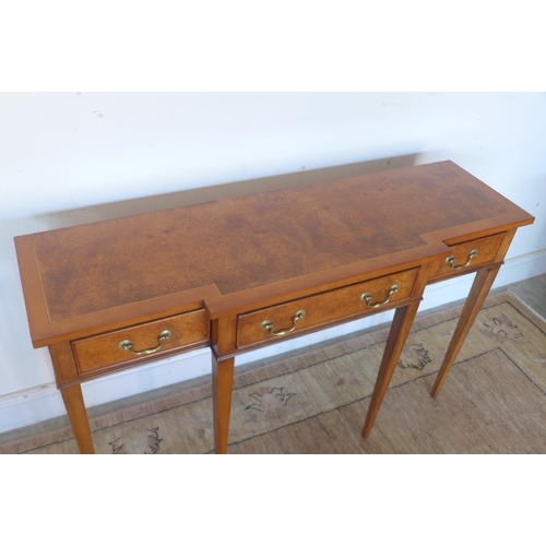 151 - A breakfront walnut hall table with three drawers, raised upon tapered legs, approx 123cm W x 76.5cm... 