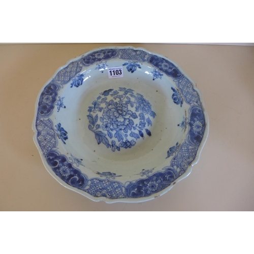 1243 - A Chinese 18th century blue and white dish with a raised central boss, decorated with flowers of the... 