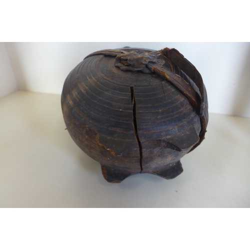 1242 - A carved moon shaped wooden flask, 26cm tall, with remains of leather strapping, general wear and cr... 