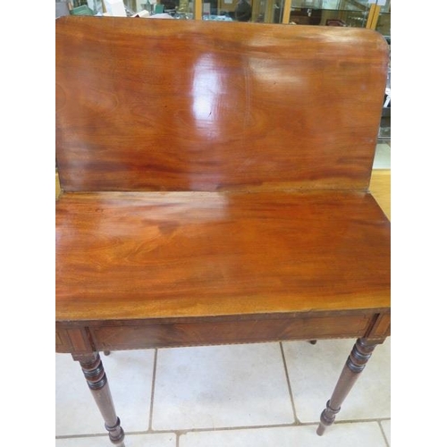 106 - A 19th century mahogany fold over tea table on turned legs