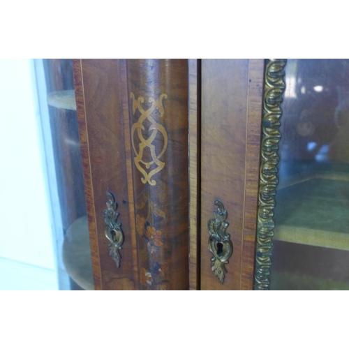 107 - A 19th century walnut marquetry inlaid three door side cabinet, with bowed glass side doors, 108cm t... 