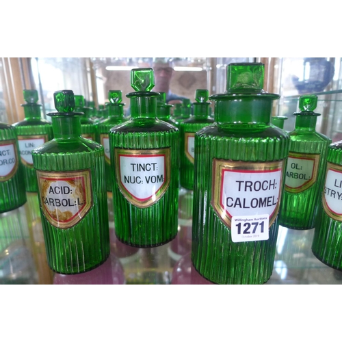 1271 - A collection of seventeen green glass chemist bottles, all with gilt edge labels, most generally goo... 