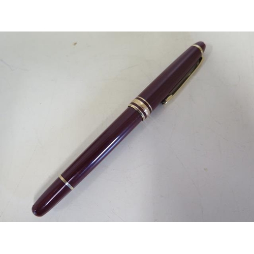 1273 - A Montblanc maroon plunger fountain pen with a 4810 14ct nib, 13.5cm long, generally good, not teste... 