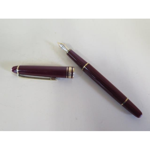 1273 - A Montblanc maroon plunger fountain pen with a 4810 14ct nib, 13.5cm long, generally good, not teste... 