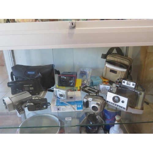 1277 - A collection of vintage and later camera cine and camcorder equipment including a Polaroid 320 land ... 