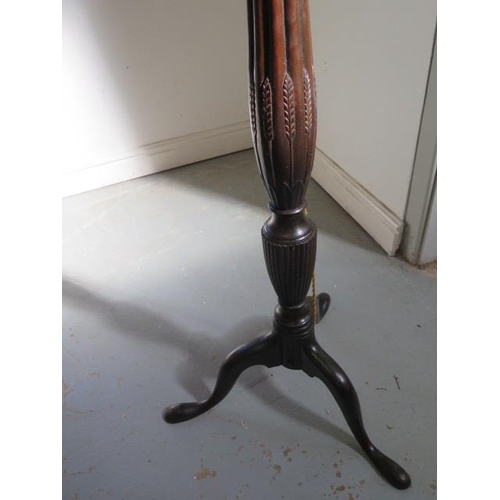 130 - A Georgian mahogany standard lamp with shaped and reeded column, enhanced with carved wheat ears, re... 