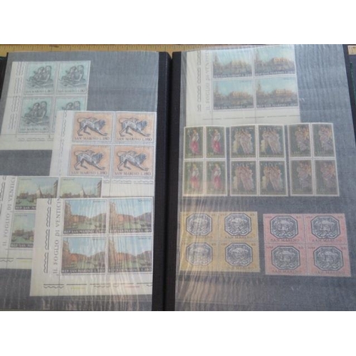 1360 - A collection of primarily mint hinged San Marino stamps, including in blocks of four, in a stock boo... 