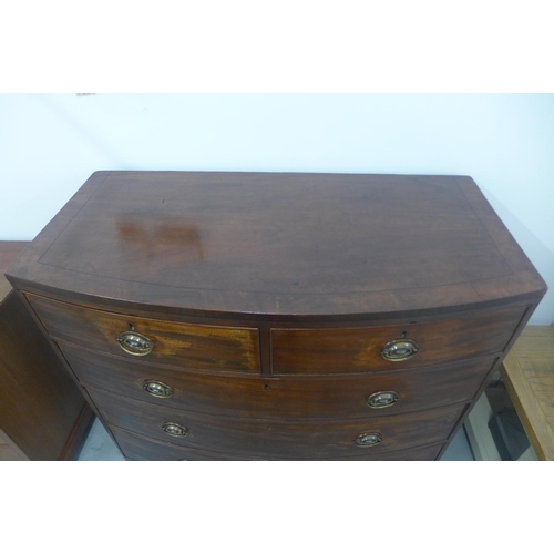 143 - A Georgian mahogany and cross banded ebony strung bow fronted chest of two over three drawers, in po... 