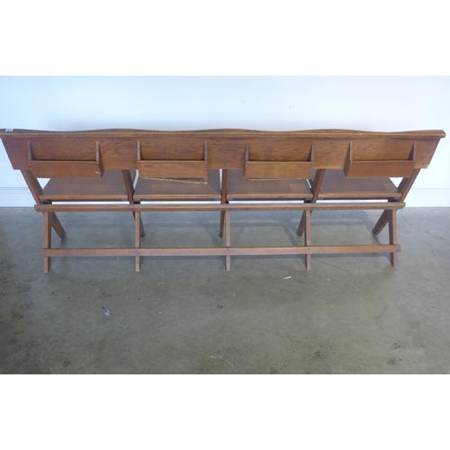 170 - An oak four seat folding bench, 211cm long, 80cm tall