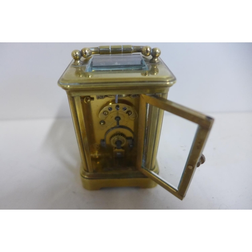 213 - An 8 day miniature carriage clock, 8cm tall