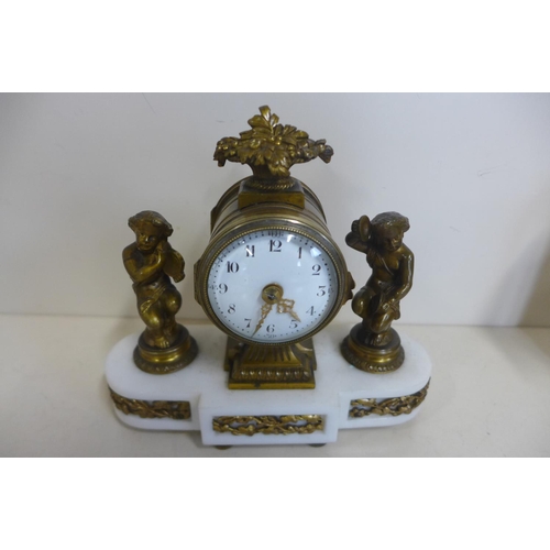 217 - An 8 cay French mantle clock on white marble base, showing clock with figures each side, the movemen... 