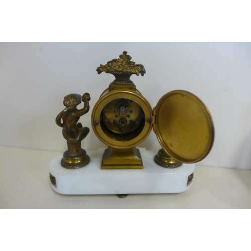 217 - An 8 cay French mantle clock on white marble base, showing clock with figures each side, the movemen... 