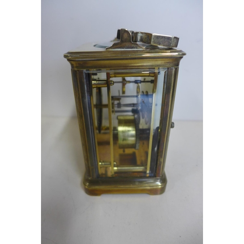 218 - An 8 day brass carriage clock, 14cm tall, with key, running, generally good