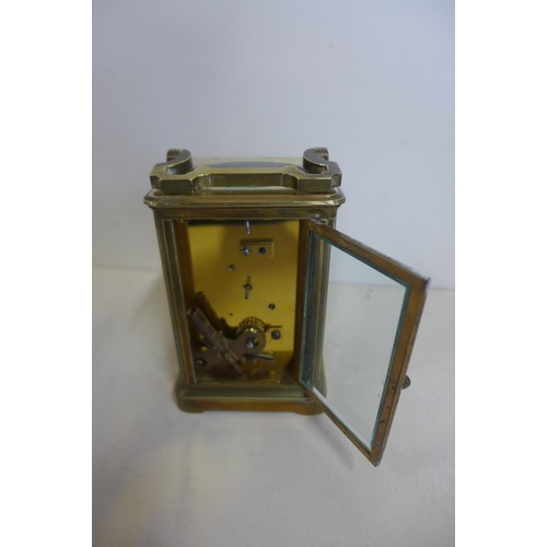 218 - An 8 day brass carriage clock, 14cm tall, with key, running, generally good