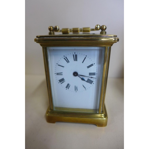 220 - An 8 day carriage clock with case - 12cm tall, with key and running but stops