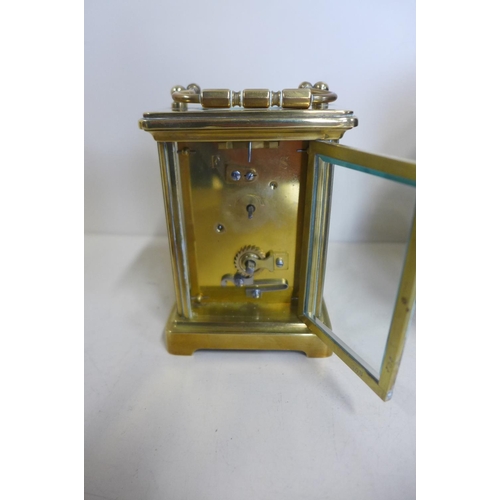 220 - An 8 day carriage clock with case - 12cm tall, with key and running but stops