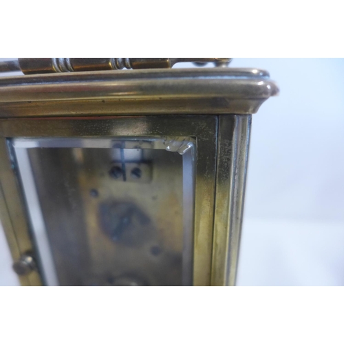 222 - An 8 day carriage clock, 12cm tall, running with key, chip to one glass