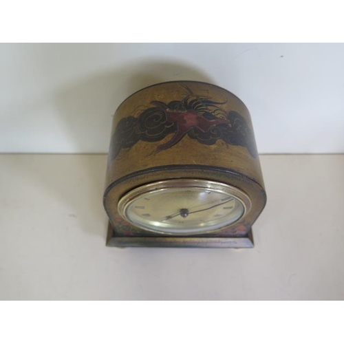 223 - A chinoiserie decorated mantle clock, 15cm tall, in running order