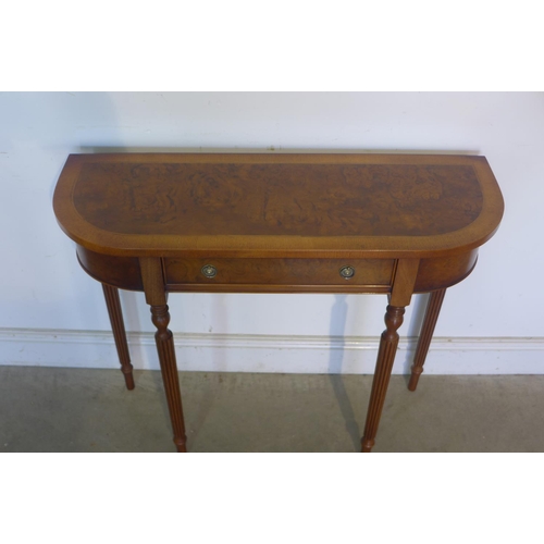 24 - A walnut D shaped hall table with a single drawer on turned legs, made by a local craftsman to a hig... 