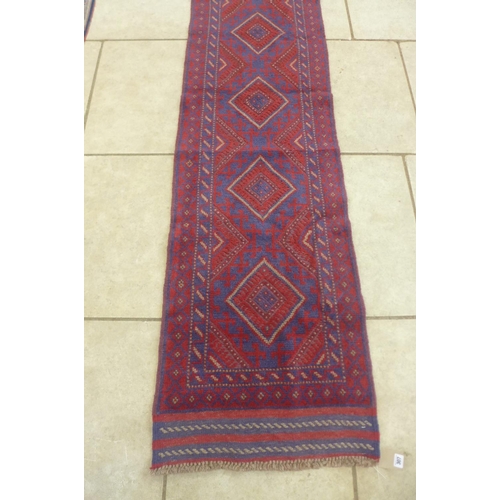 307 - A hand knotted woollen Meshwani runner, 250cm x 62cm