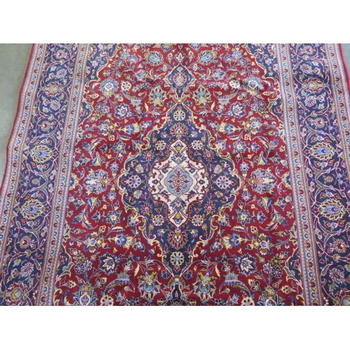 325 - A hand knotted woollen Persian rug, 228cmx 144cm