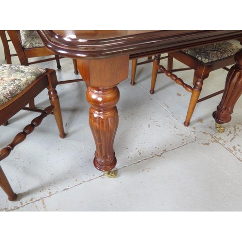 62 - A mahogany effect 19th century style pullout dining table with one leaf and six ladder back dining c... 