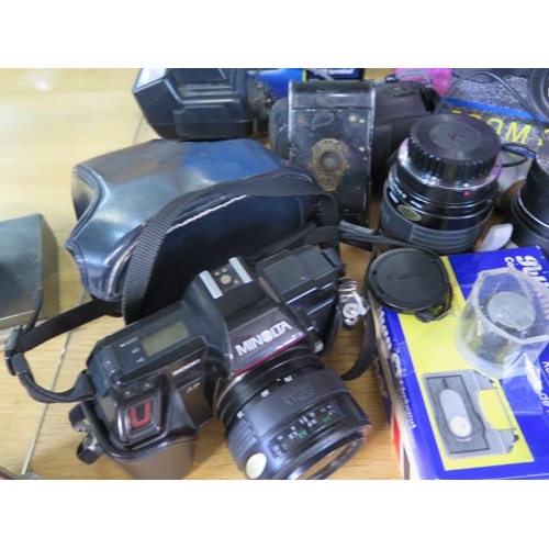 1255 - A collection of cameras, equipment and lenses including a Minolta 5000, Praktica EE2 and a bellows c... 