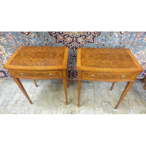 8 - A pair of walnut bow fronted lamp tables, each with a frieze drawer on square tapering legs, 77cm ta... 