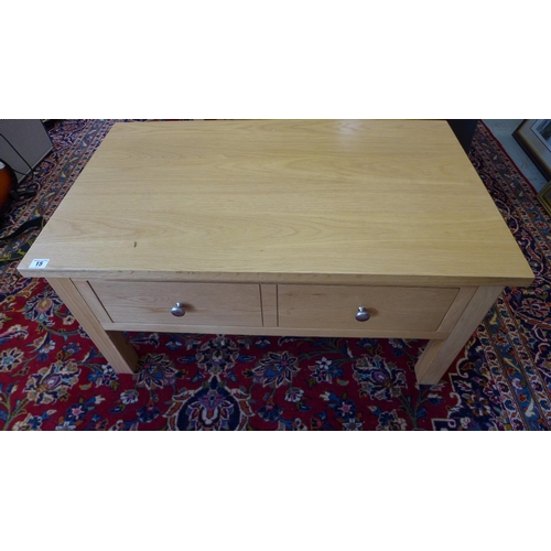 15 - A modern oak coffee table with a single double sided drawer - Height 45cm x 90cm x 55cm - in clean c... 