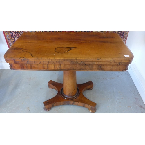 34 - A 19th century Rosewood fold over card table on a turned colomn and platform base. 92cm wide.
