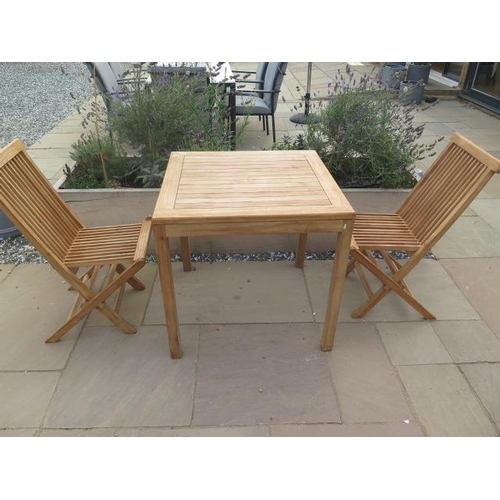 13 - A new boxed teak bistro table 70cm x 70cm and two folding dining chairs.