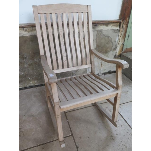 29 - A teak garden rocking chair