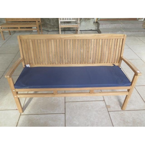 36 - A teak hardwood bench with a blue cushion 150cm wide