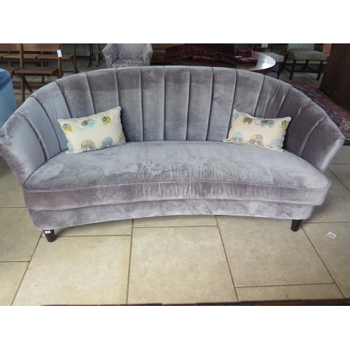 48 - A grey upholstered banana shaped sofa, 90 cm tall x 213 cm wide x 100 cm