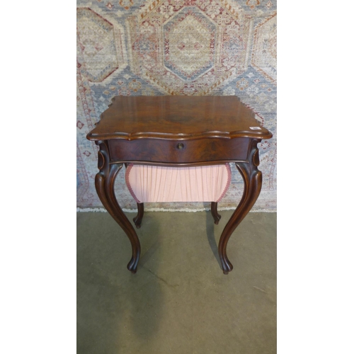 65 - A 19th century mahogany work box on shaped legs with a shaped lift up top revealing a sliding fitted... 