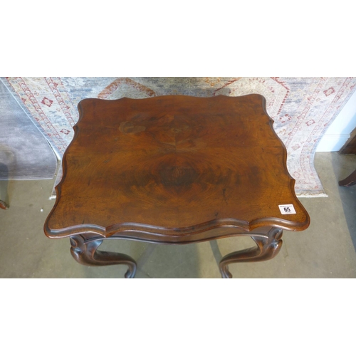 65 - A 19th century mahogany work box on shaped legs with a shaped lift up top revealing a sliding fitted... 