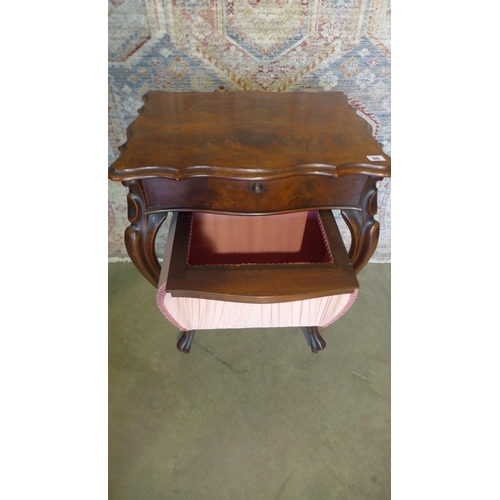 65 - A 19th century mahogany work box on shaped legs with a shaped lift up top revealing a sliding fitted... 