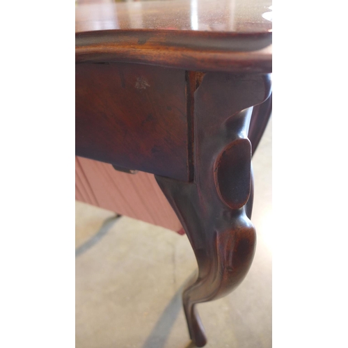 65 - A 19th century mahogany work box on shaped legs with a shaped lift up top revealing a sliding fitted... 