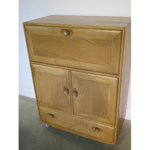11 - An Ercol blonde elm bureau cabinet with 2 doors and a drawer in good condition, minor scratches to t... 