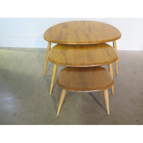 12 - An Ercol blonde elm nest of 3 pebble tables, repair to base of largest otherwise good condition
