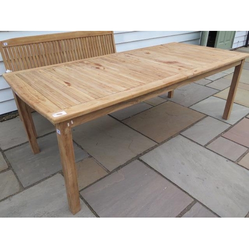 23 - A teak garden table measuring 218cm x 100cm, in sound sturdy condition