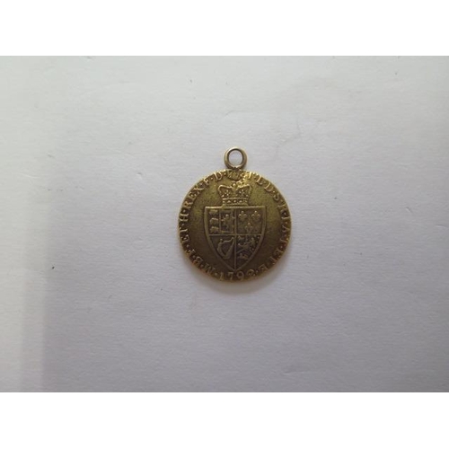 923 - A George III gold spade Guinea dated 1792 with a pendant mount, total weight approx 8.4gs

Removed f... 