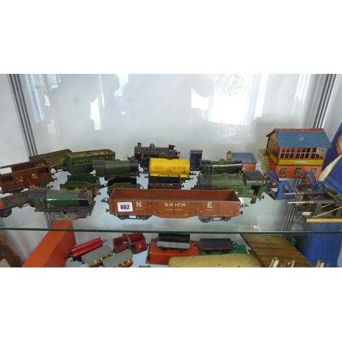 962 - A large quantity of O gauge tin plate railway rolling stock including some buildings and locos. All ... 