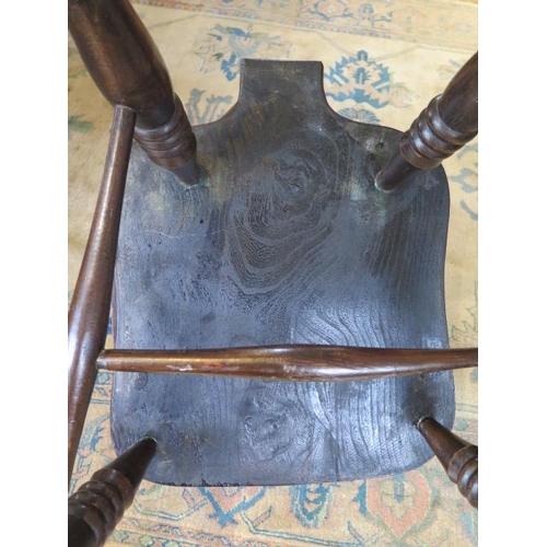 100 - An ash and elm stick back Windsor chair, stamped 1938 to the underside, 106cm high, general age rela... 