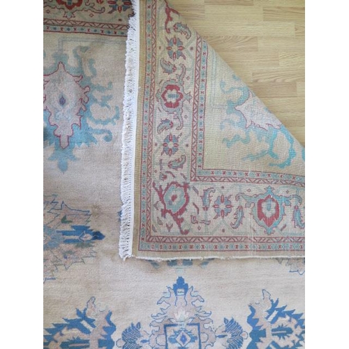 253 - A cream ground rug with wide foliate border, 3m x 2.03m, two thirds wide heavy sun fading and small ... 