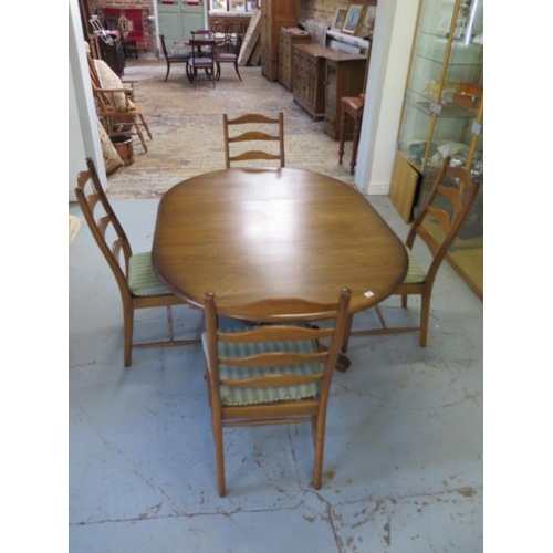 26 - An Ercol elm oval extending dining table and 4 chairs with seat pads, 74cm tall x 166cm x 114cm exte... 