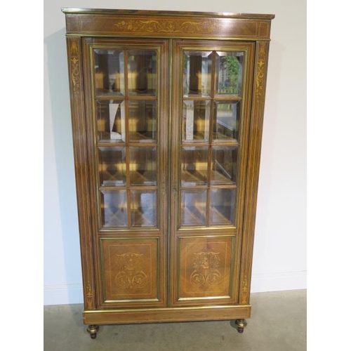 50 - A French 19th century rosewood inlaid bookcase, the glazed doors opening to reveal five internal she... 